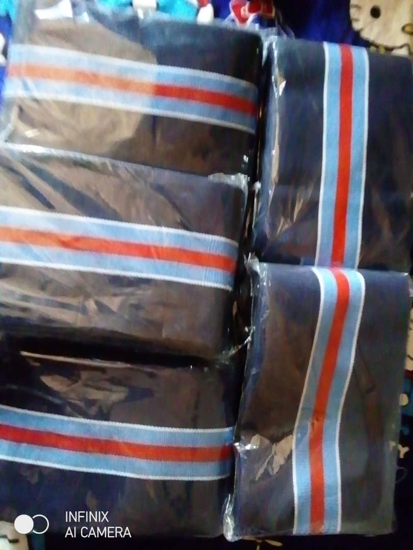 Detail of the Takete-Ide fabric: navy cloth with red, white and pale blue stripes, wrapped in packs