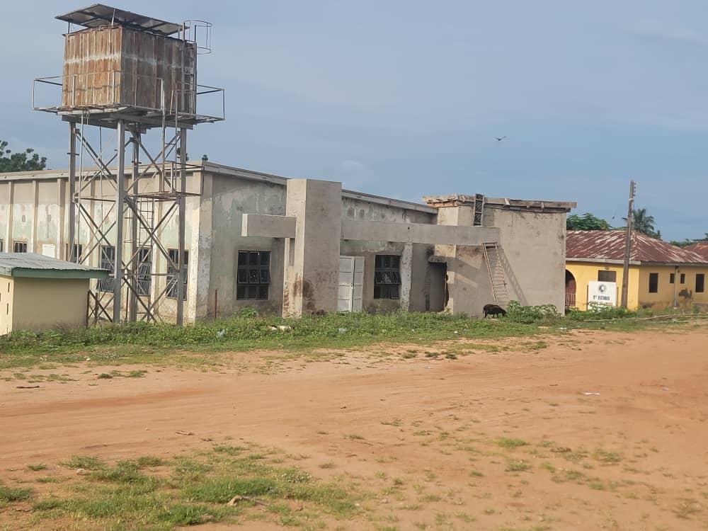 Church premises at Takete-Ide with an unfinished block building and an elevated steel water tank